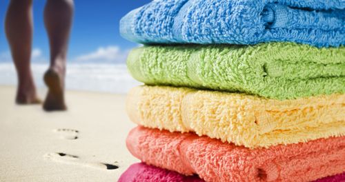 Beach towels and kitchen linens prepared for a short-term rental property